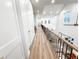 Second story hallway overlooking the living room with views through large windows at 3180 Lee Dr, Buford, GA 30518
