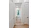Bright hallway featuring wood-look floors and white doors leading to the outdoors at 3180 Lee Dr, Buford, GA 30518
