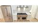 Elegant kitchen boasts stainless steel appliances, white cabinets, and quartz countertops at 3180 Lee Dr, Buford, GA 30518