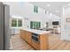 Stylish kitchen with a center island, stainless steel appliances, and easy access to the living and dining spaces at 3180 Lee Dr, Buford, GA 30518