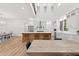 Spacious kitchen showcasing a large center island, stainless steel appliances, white cabinetry and an adjoining dining area at 3180 Lee Dr, Buford, GA 30518