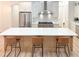 Spacious kitchen featuring a large island with seating, stainless steel appliances, and white cabinets at 3180 Lee Dr, Buford, GA 30518