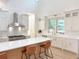 Bright, modern kitchen with white cabinets, stainless steel appliances, and a spacious island with bar seating at 3180 Lee Dr, Buford, GA 30518