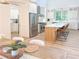 Modern kitchen featuring white cabinets, island with seating, and stainless steel appliances at 3180 Lee Dr, Buford, GA 30518