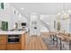 Elegant kitchen featuring a center island with built-in microwave, a dining area, and access to other parts of the home at 3180 Lee Dr, Buford, GA 30518