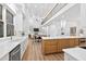 Open kitchen boasts custom cabinets, an island and flows into the living area at 3180 Lee Dr, Buford, GA 30518