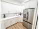 Kitchenette featuring white cabinets, stainless steel refrigerator, and marble countertop at 3180 Lee Dr, Buford, GA 30518