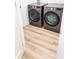 Newer gray front load washer and dryer set inside a laundry room with wood-look flooring at 3180 Lee Dr, Buford, GA 30518