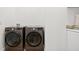Modern laundry room with side-by-side washer and dryer at 3180 Lee Dr, Buford, GA 30518