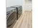 Contemporary laundry area with front-loading washer and dryer units at 3180 Lee Dr, Buford, GA 30518
