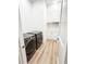 Modern laundry room with gray front load washer and dryer and white built-in shelving and cabinets at 3180 Lee Dr, Buford, GA 30518