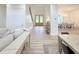 Bright, open-concept living space with hardwood floors flowing into the dining area and an inviting entryway at 3180 Lee Dr, Buford, GA 30518