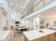 Open concept living space featuring a modern kitchen, dining area, and living room with fireplace at 3180 Lee Dr, Buford, GA 30518