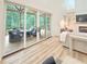 Beautiful living room with a stone fireplace and large sliding glass doors to the screened-in porch at 3180 Lee Dr, Buford, GA 30518
