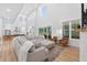 Open-concept living room featuring large windows, modern decor, and wood flooring at 3180 Lee Dr, Buford, GA 30518