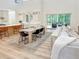 Open-concept living space featuring a bright kitchen, dining area, and access to the screened-in porch at 3180 Lee Dr, Buford, GA 30518