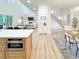 Bright open-concept living spaces featuring open kitchen, living room with fireplace, and staircase at 3180 Lee Dr, Buford, GA 30518