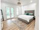 A stylish main bedroom featuring French doors leading to a private balcony at 3180 Lee Dr, Buford, GA 30518
