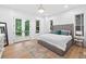 Cozy main bedroom has ample natural light, a large bed and a view of the deck at 3180 Lee Dr, Buford, GA 30518