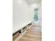This mudroom has built-in bench with storage, beautiful floors, and backyard access at 3180 Lee Dr, Buford, GA 30518