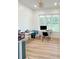 Well-lit home office featuring a modern desk, ample natural light, and hardwood floors at 3180 Lee Dr, Buford, GA 30518