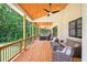 Covered patio offers cozy seating areas, wood ceiling, ceiling fans and a scenic view of the backyard at 3180 Lee Dr, Buford, GA 30518