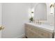 Elegant powder room featuring stylish vanity, modern lighting, and chic mirror at 3180 Lee Dr, Buford, GA 30518