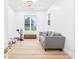 Bright room with a grey sofa and workout equipment in front of a window with natural light at 3180 Lee Dr, Buford, GA 30518