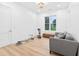 Bright room with a grey sofa and workout equipment in front of a window with natural light at 3180 Lee Dr, Buford, GA 30518