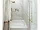 Modern bathroom features a shower with marble tile and gold fixtures at 3180 Lee Dr, Buford, GA 30518