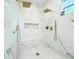 Luxurious walk-in shower with marble tile, double shower heads, and a built-in bench at 3180 Lee Dr, Buford, GA 30518