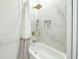 Modern bathroom features a shower with marble tile and gold fixtures at 3180 Lee Dr, Buford, GA 30518