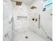 This bathroom features a luxurious marble shower with dual showerheads, a built-in bench and a hexagon mosaic tile floor at 3180 Lee Dr, Buford, GA 30518