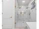 Luxurious glass shower with marble accents, dual shower heads, and gold hardware at 3180 Lee Dr, Buford, GA 30518