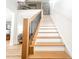 Bright staircase with wood and black metal railings connecting two stories with light wood floors at 3180 Lee Dr, Buford, GA 30518