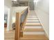 Staircase with light wood treads and black railings leads to the second floor at 3180 Lee Dr, Buford, GA 30518