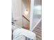 Stairway featuring wood steps, handrail, and white walls lit by sconce at 3180 Lee Dr, Buford, GA 30518