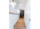 Stairway featuring wood steps and white walls illuminated by sconce lighting at 3180 Lee Dr, Buford, GA 30518