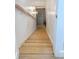 Stairwell featuring wooden steps, lighting fixtures, and a hardwood handrail at 3180 Lee Dr, Buford, GA 30518