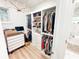Bright walk-in closet with custom organizers and a dresser, offering a stylish and practical storage solution at 3180 Lee Dr, Buford, GA 30518