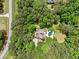 Aerial view of a secluded home nestled among mature trees and lush greenery with a backyard pool at 8170 Hurakan Creek Xing, Cumming, GA 30028
