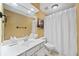 A cozy bathroom with a white vanity, large mirror, and tile flooring at 8170 Hurakan Creek Xing, Cumming, GA 30028