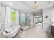 A luxurious bathroom featuring a soaking tub, large glass shower, and decorative wood vanity at 8170 Hurakan Creek Xing, Cumming, GA 30028