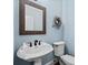 Charming half bathroom features a vessel sink, custom mirror, and fresh paint at 8170 Hurakan Creek Xing, Cumming, GA 30028