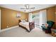 Cozy bedroom with a ceiling fan, one window dressed with white curtains, and a rocking chair at 8170 Hurakan Creek Xing, Cumming, GA 30028