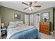 This bedroom features a ceiling fan and is well-lit, with a linen closet and bathroom access at 8170 Hurakan Creek Xing, Cumming, GA 30028