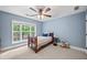 Cozy bedroom featuring a twin bed, a ceiling fan, and a window with a view at 8170 Hurakan Creek Xing, Cumming, GA 30028