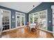 Dining area with a large window, hardwood floors, and an adjacent set of french doors at 8170 Hurakan Creek Xing, Cumming, GA 30028