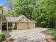 Attached two-car garage with brick accents and a covered portico, providing convenient parking and curb appeal at 8170 Hurakan Creek Xing, Cumming, GA 30028