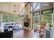 Cozy sunroom featuring a fireplace and views of the pool at 8170 Hurakan Creek Xing, Cumming, GA 30028